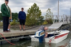 Tony and Bob watch Al fine tune the '59 Evinrude 18