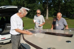 Al, Dave M and Doug check out Al's racing pics