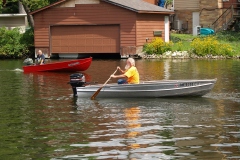 Scott gives Jim B a hand; Tom heads out on the lake